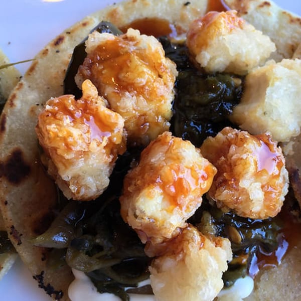 Fried shrimp with sweet sauce and dark greens on a flatbread from 38 Degrees Ale House & Grill.